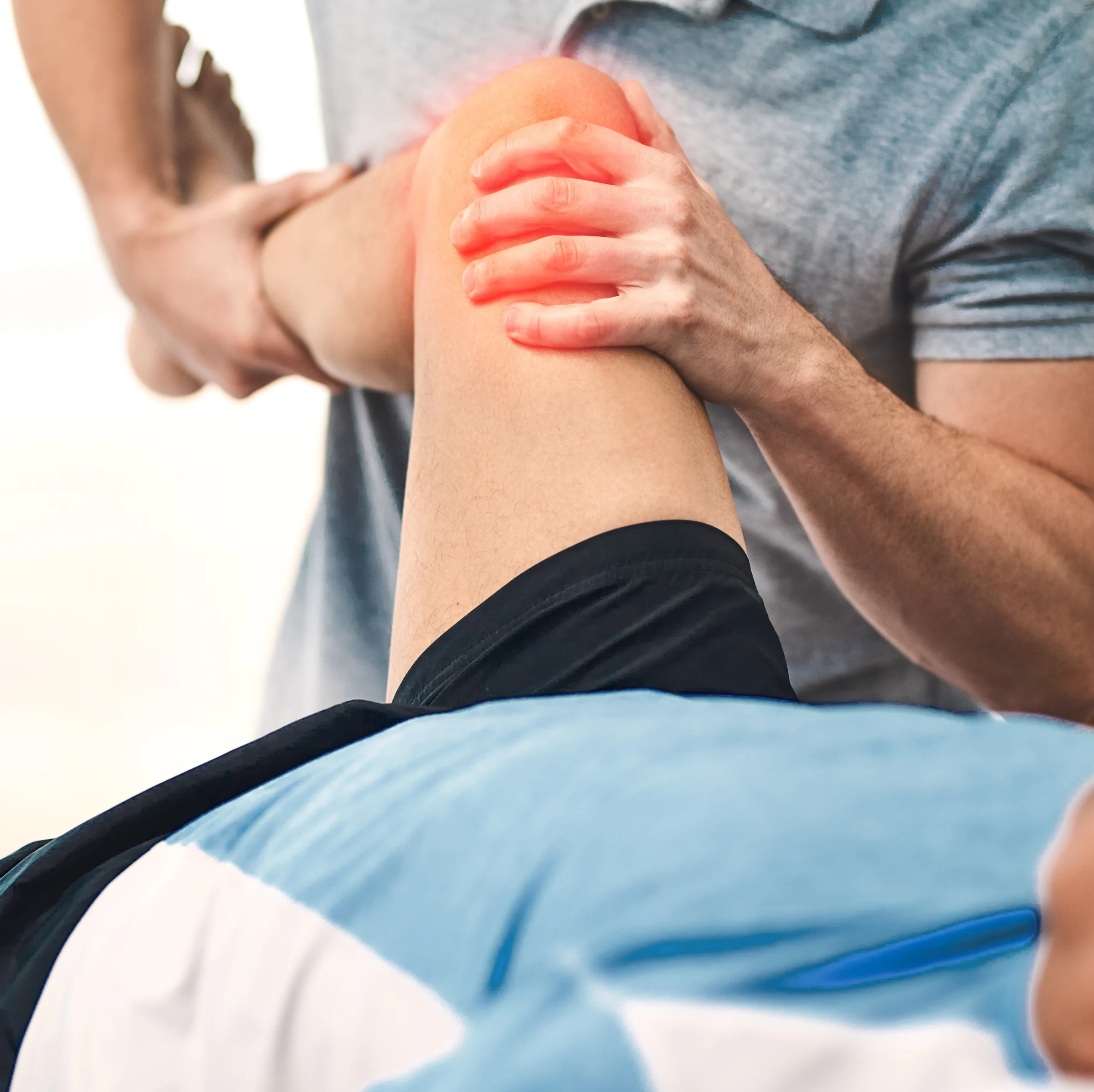 Caregiver helping a patient with rehabilitation exercises to restore knee mobility
