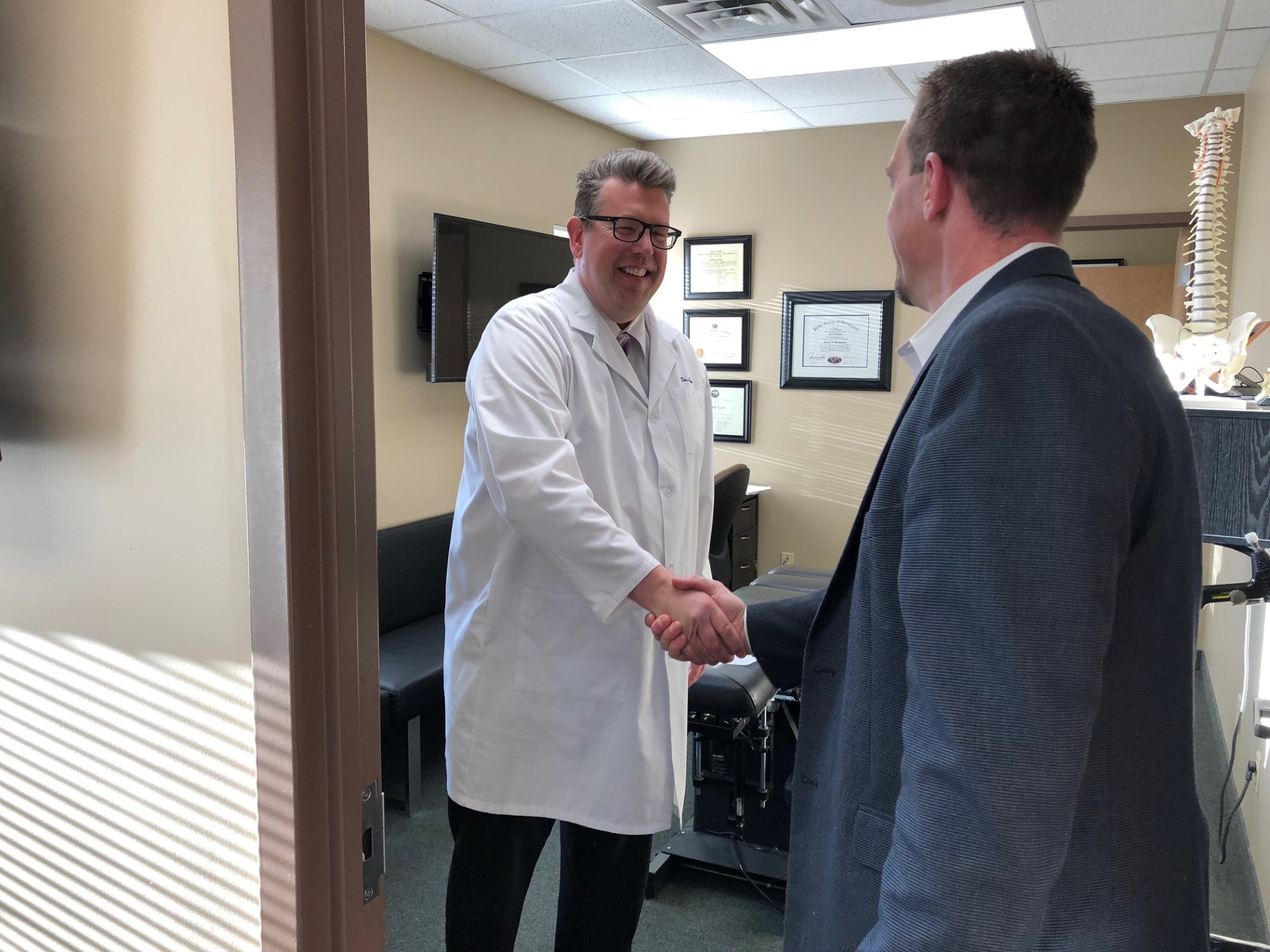 Dr. Daniel Larsen greeting a referring attorney at Twin Cities Chiropractic Spine and Injury Center