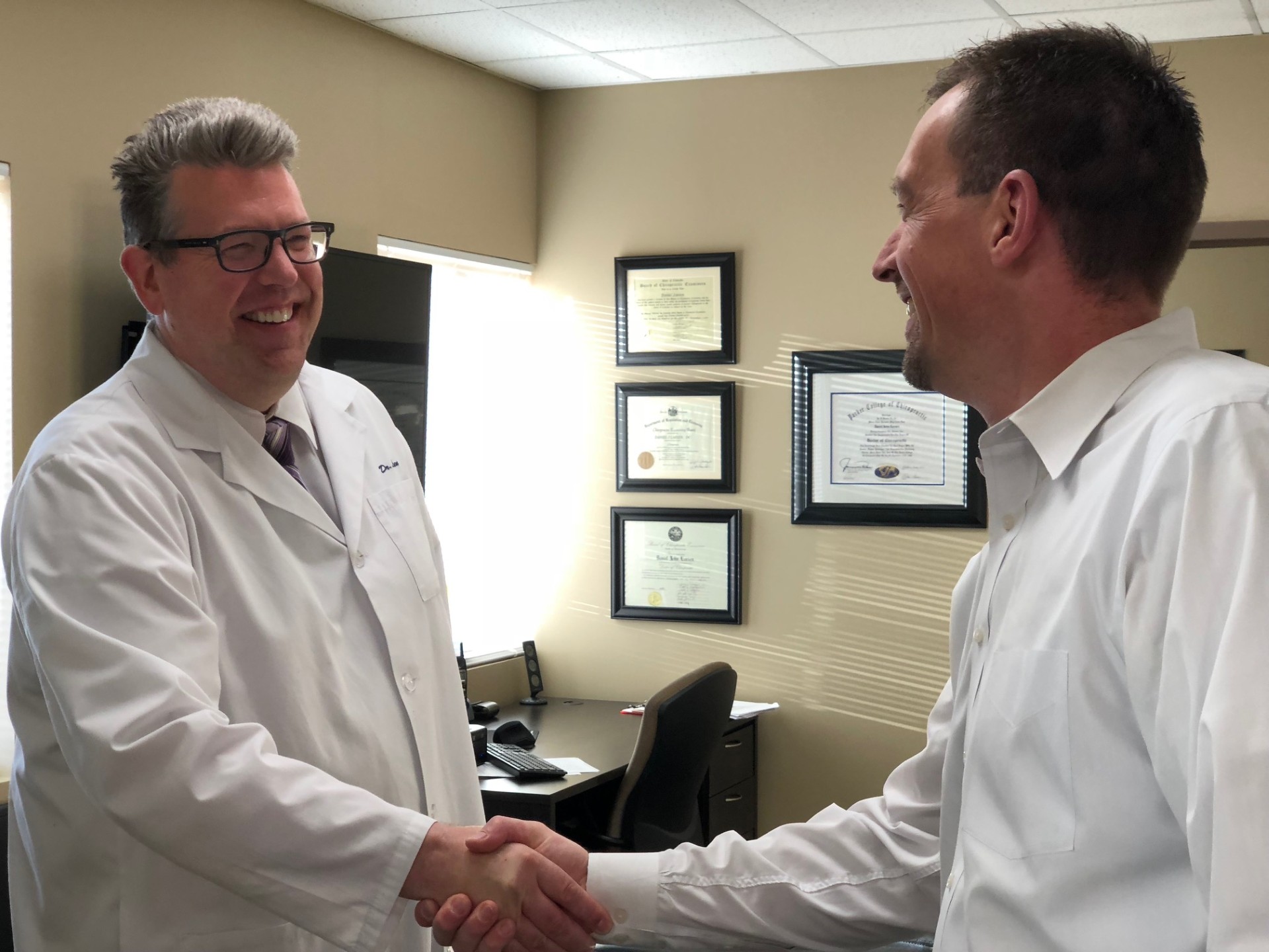 Dr. Daniel Larsen welcoming a new patient at Twin Cities Chiropractic Spine and Injury Center